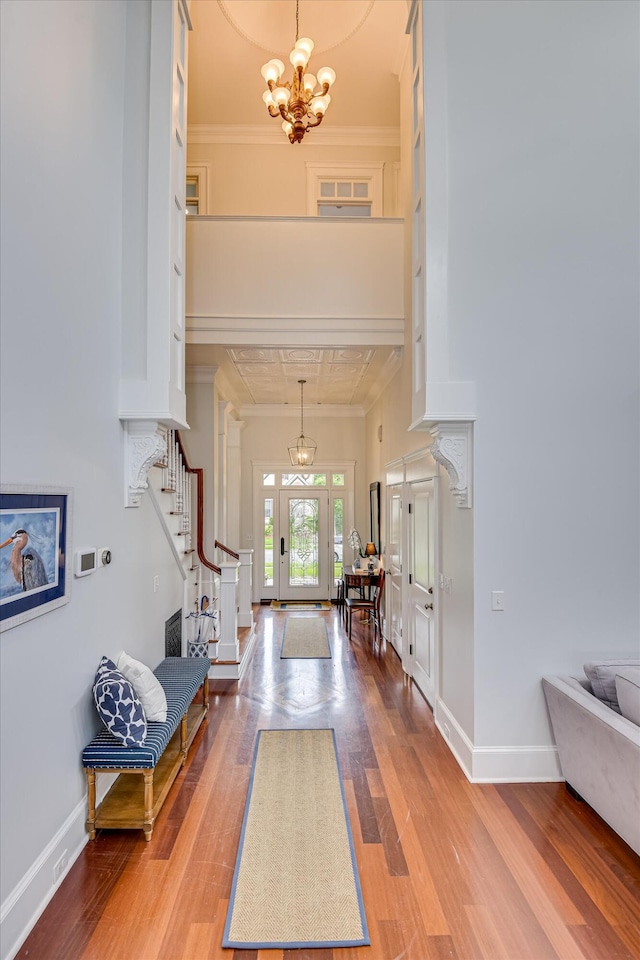 324 E Shoreline Dr, North Augusta, SC 29841 - foyer featuring crown molding, a chandelier, wood finished floors, stairs, and baseboards