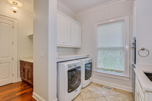324 E Shoreline Dr, North Augusta, SC 29841 - laundry area with cabinet space, washer and dryer, crown molding, and baseboards