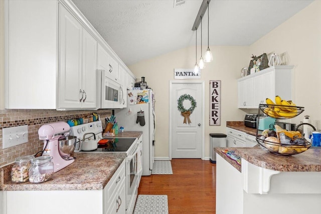 752 Keyes Dr, Grovetown, GA 30813 - kitchen with white appliances, tasteful backsplash, dark wood-style flooring, white cabinetry, and vaulted ceiling