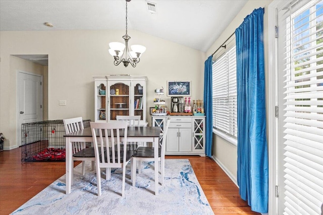 752 Keyes Dr, Grovetown, GA 30813 - dining space with a chandelier, wood finished floors, vaulted ceiling, and baseboards