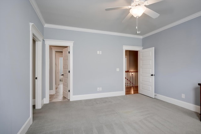 unfurnished bedroom featuring carpet floors, baseboards, and ornamental molding