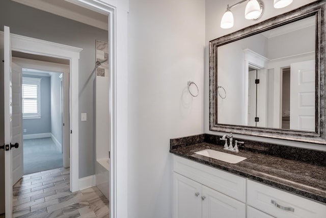 full bathroom with vanity, baseboards, and bathtub / shower combination