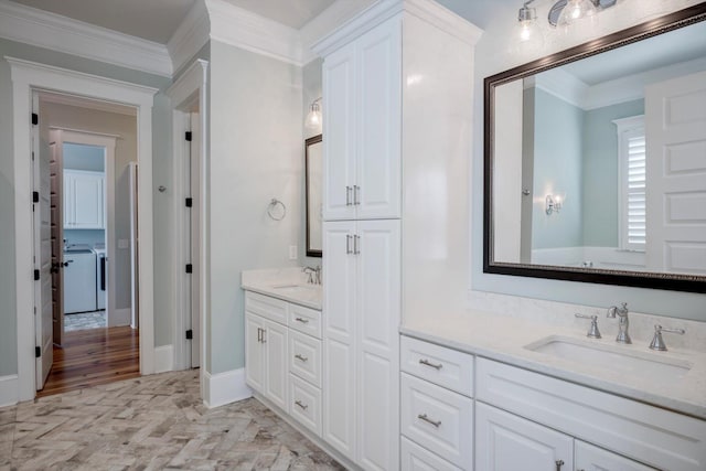 bathroom with crown molding, vanity, wood finished floors, and washing machine and clothes dryer