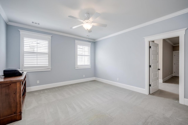interior space featuring carpet flooring, ceiling fan, baseboards, visible vents, and ornamental molding