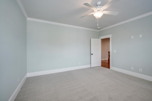 unfurnished room with crown molding, a ceiling fan, and carpet