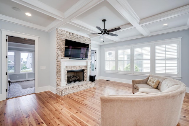 living area with ceiling fan, coffered ceiling, and hardwood / wood-style flooring
