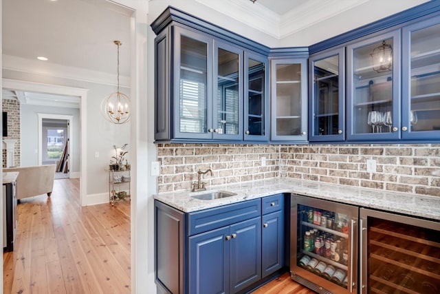 bar with wine cooler, ornamental molding, tasteful backsplash, and a sink
