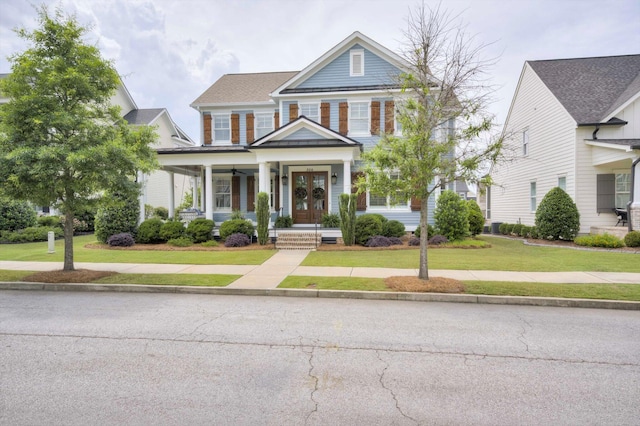 greek revival inspired property with a porch and a front lawn