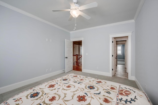 bedroom featuring baseboards, ceiling fan, light carpet, and ornamental molding
