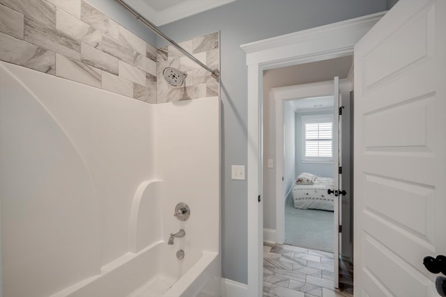 bathroom with baseboards and tub / shower combination