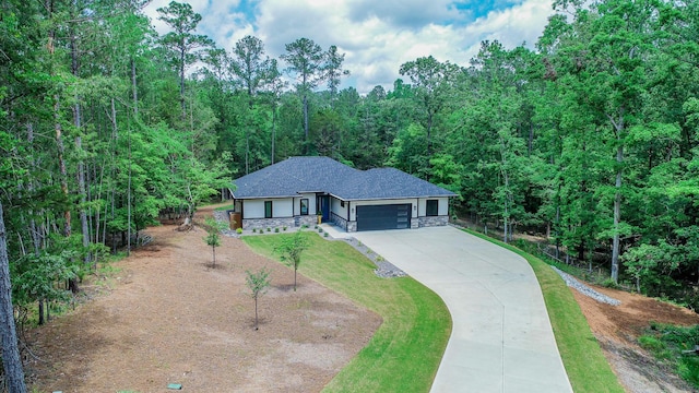 217 Cove Point Ln, Mccormick, SC 29835 - view of front of home with stone siding, a garage, concrete driveway, a forest view, and roof with shingles