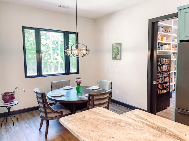 217 Cove Point Ln, Mccormick, SC 29835 - dining space with light wood-style flooring, a chandelier, and baseboards