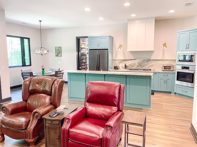 217 Cove Point Ln, Mccormick, SC 29835 - kitchen with stainless steel appliances, light wood-type flooring, a chandelier, a center island, and recessed lighting