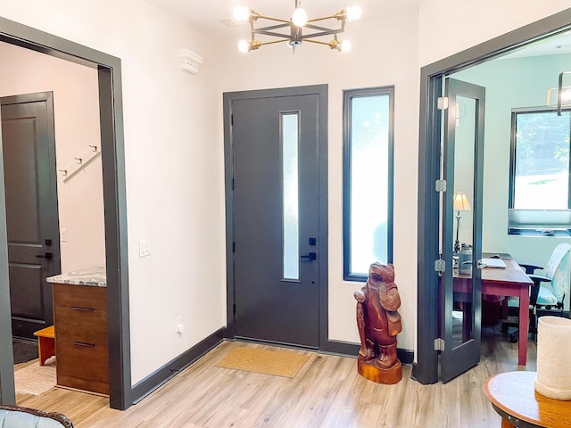 217 Cove Point Ln, Mccormick, SC 29835 - entryway featuring light wood finished floors, a chandelier, and baseboards