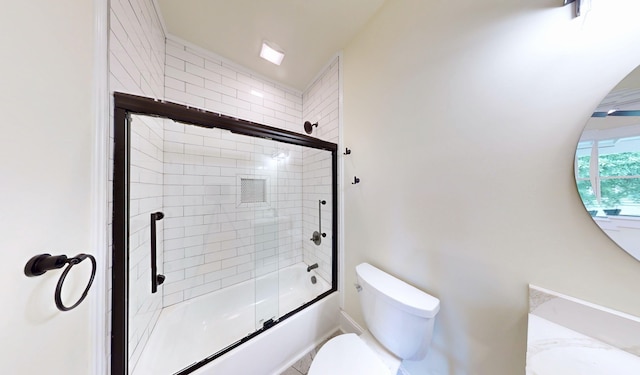 bathroom featuring combined bath / shower with glass door and toilet