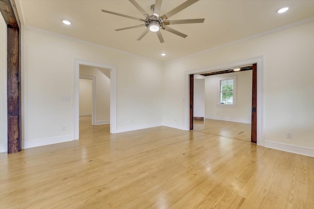 spare room with crown molding, light hardwood / wood-style floors, and ceiling fan