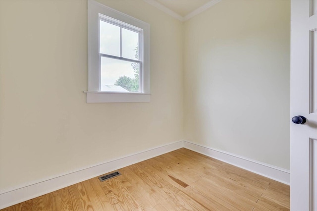 unfurnished room with wood-type flooring and crown molding