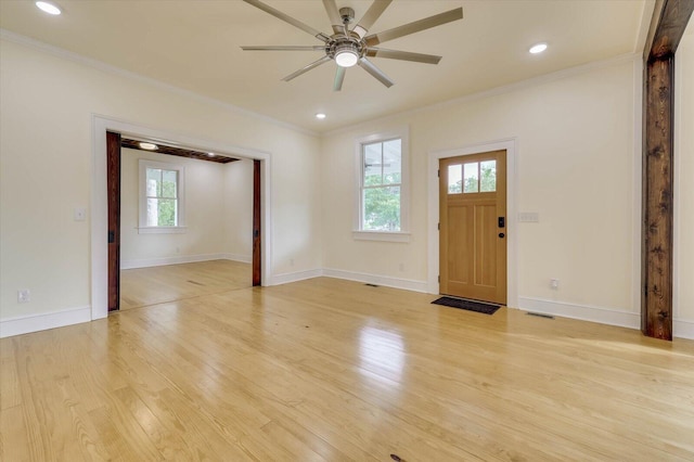 foyer entrance featuring crown molding, ceiling fan, and light hardwood / wood-style flooring