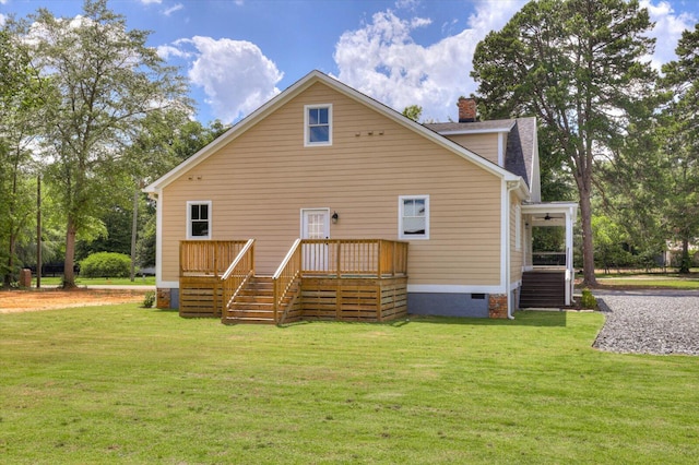 back of property featuring a wooden deck and a lawn