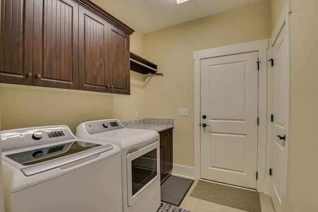 washroom featuring cabinets and washing machine and clothes dryer