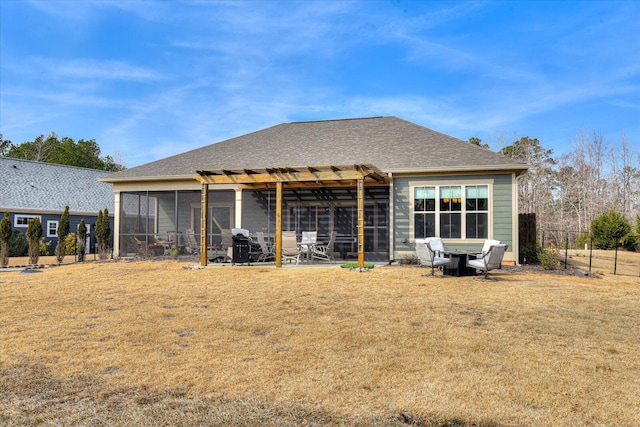 back of house with a yard and a sunroom