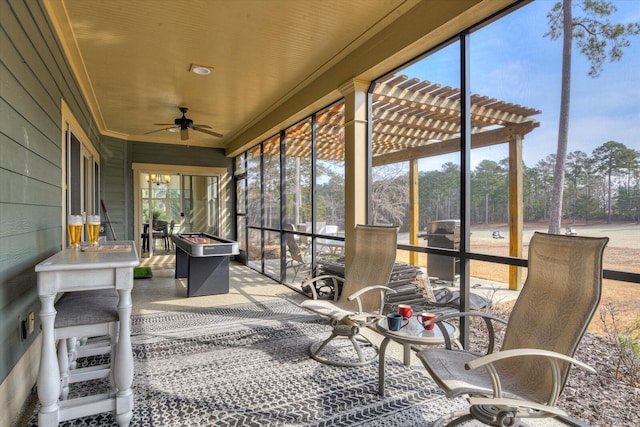 sunroom / solarium featuring ceiling fan