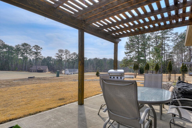 view of patio with area for grilling and a pergola