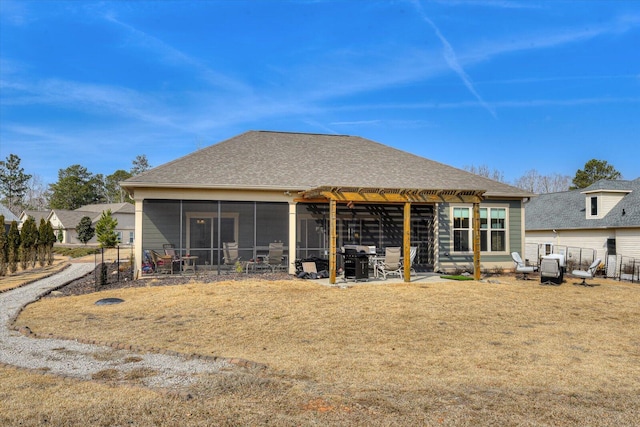 rear view of house featuring a sunroom