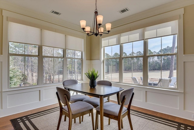 dining area with a notable chandelier and light wood-type flooring