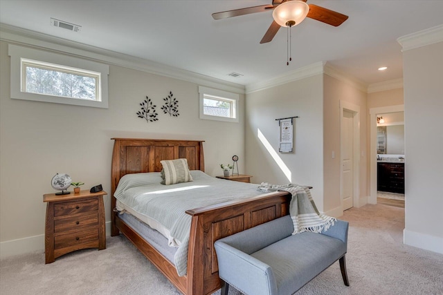 carpeted bedroom featuring crown molding, ensuite bathroom, and ceiling fan