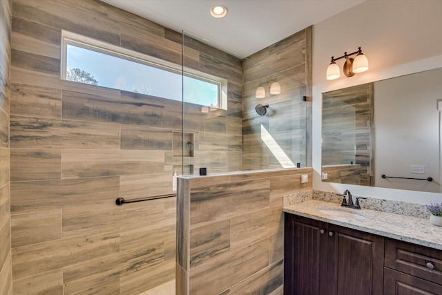 bathroom featuring vanity and tiled shower