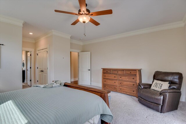 carpeted bedroom with ceiling fan and ornamental molding