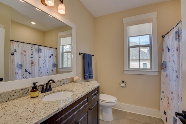 bathroom with vanity, tile patterned flooring, a wealth of natural light, and toilet