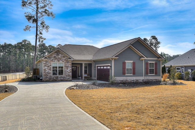 craftsman house with a garage and a front yard