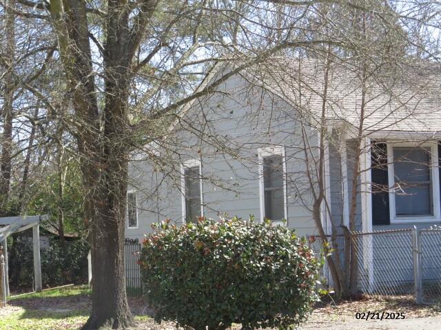 view of side of home featuring fence