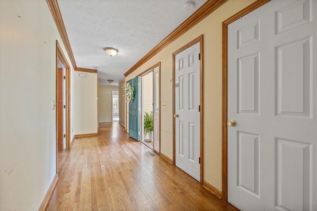 40 Driftwood Ct, Aiken, SC 29801 - hallway with crown molding, baseboards, light wood finished floors, and a textured ceiling