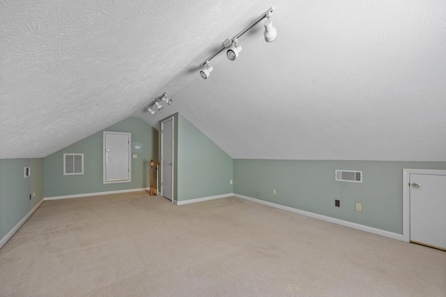 40 Driftwood Ct, Aiken, SC 29801 - additional living space with a textured ceiling, baseboards, lofted ceiling, and light colored carpet