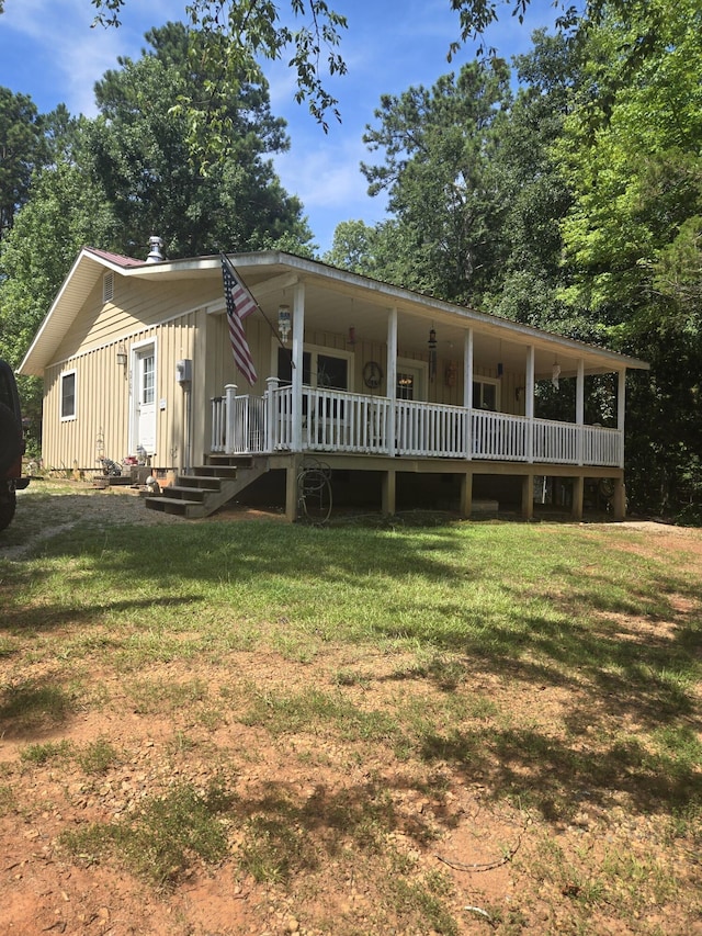 3706 Cooter Creek Rd, Elberton, GA 30635 - view of front of property with board and batten siding, a front lawn, and covered porch