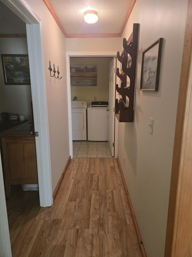 3706 Cooter Creek Rd, Elberton, GA 30635 - hall with washer and dryer, wood finished floors, and ornamental molding