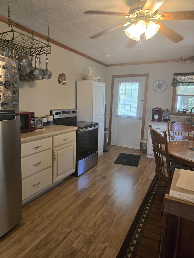 3706 Cooter Creek Rd, Elberton, GA 30635 - kitchen with stainless steel appliances, crown molding, ceiling fan, wood finished floors, and white cabinetry
