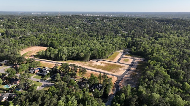 birds eye view of property featuring a wooded view