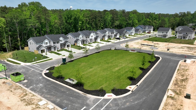 drone / aerial view with a forest view and a residential view