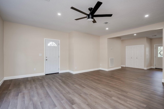 entrance foyer with a textured ceiling, ceiling fan, and light hardwood / wood-style floors