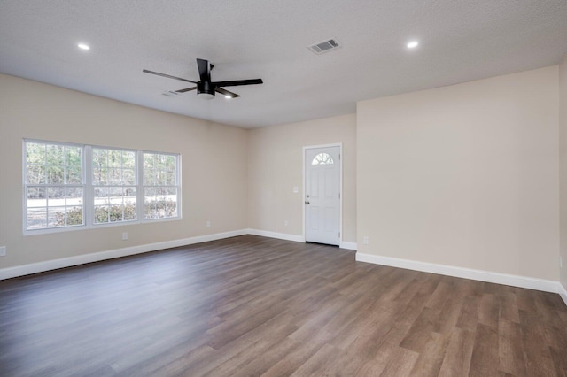 interior space featuring ceiling fan, dark hardwood / wood-style flooring, and a textured ceiling