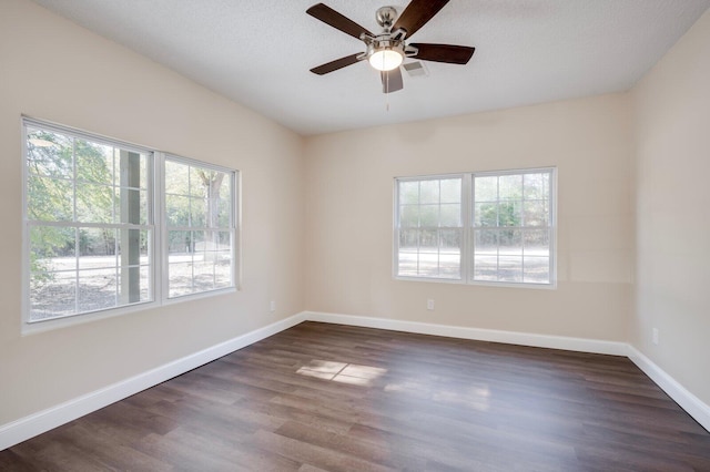 unfurnished room with ceiling fan, a textured ceiling, and dark hardwood / wood-style flooring