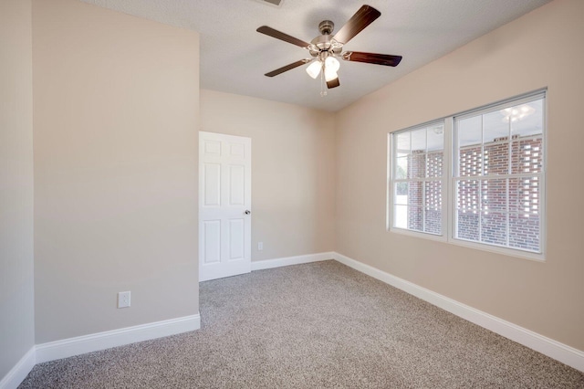 empty room featuring ceiling fan and carpet flooring