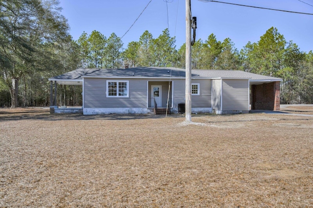 ranch-style home featuring a carport