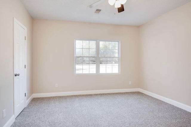 empty room featuring ceiling fan and carpet flooring