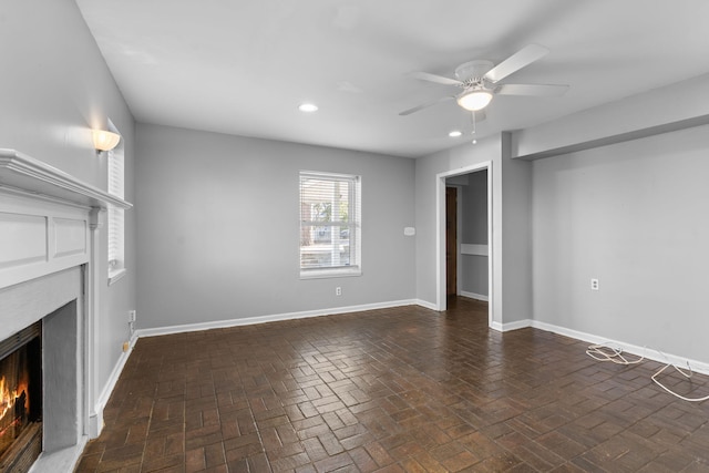 unfurnished living room featuring ceiling fan