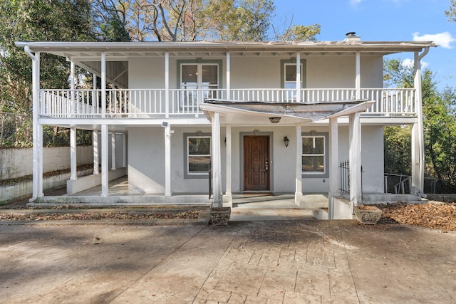 view of front of house featuring a balcony